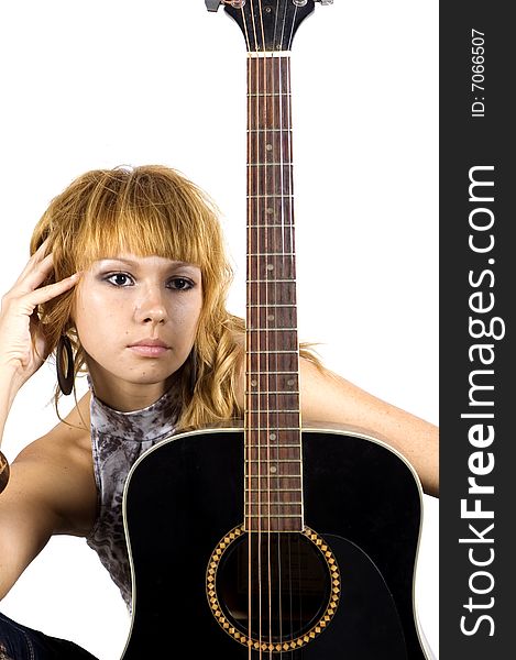 Thoughtful musician. Young, pretty girl - close portrait with black guitar.