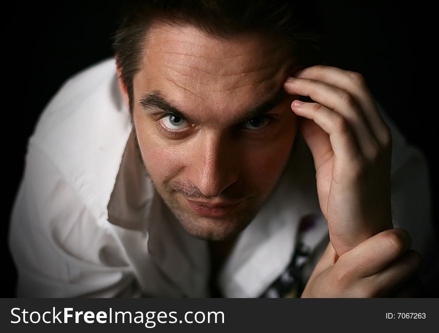 Young man in a white shirt on a black background