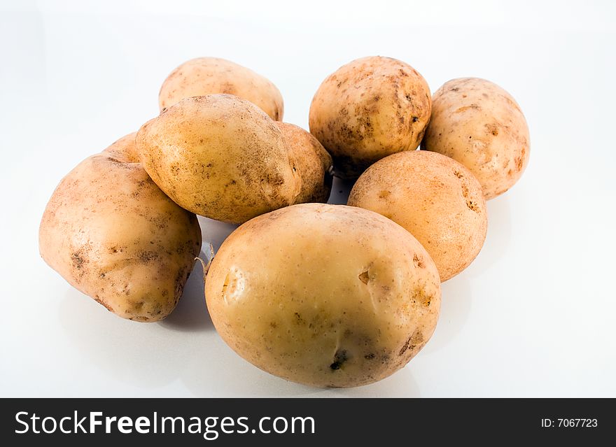 Tubers raw potatoes on a white background