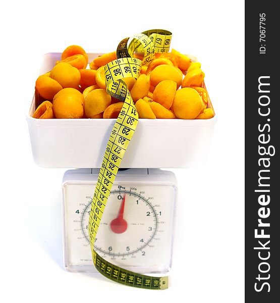 Sweet apricots, scale and tape measure isolated. Sweet apricots, scale and tape measure isolated