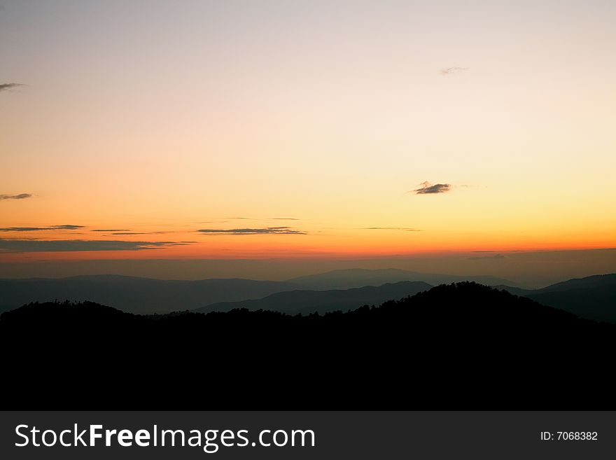 An image of a sunset in mountains