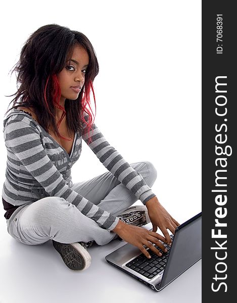 Attractive girl working on laptop against white background