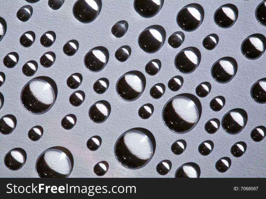 Abstract background with water drops on grey glass