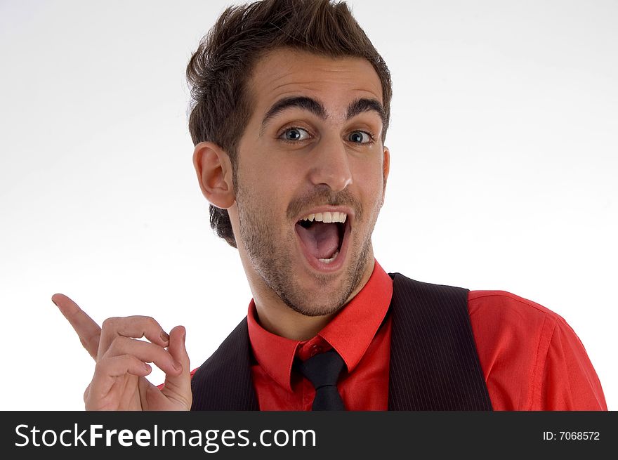 Cheerful man pointing backside on an isolated white background