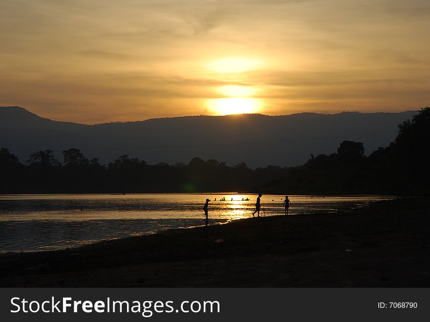 Children playing in a sunset time allong the river. Children playing in a sunset time allong the river