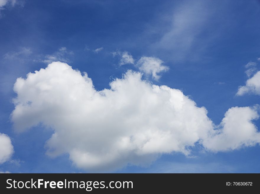 Fluffy white clouds in the blue sky. Fluffy white clouds in the blue sky