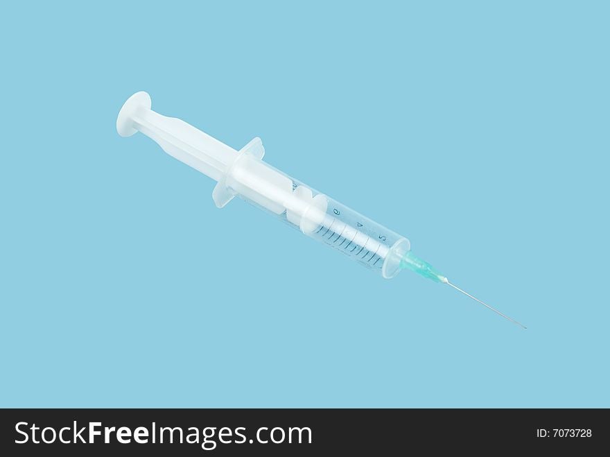 Syringe isolated on blue background