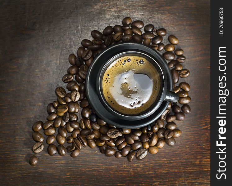 A cup of hot coffee on wooden background