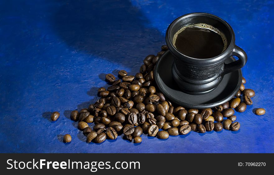 Cup of hot coffee on the old blue background