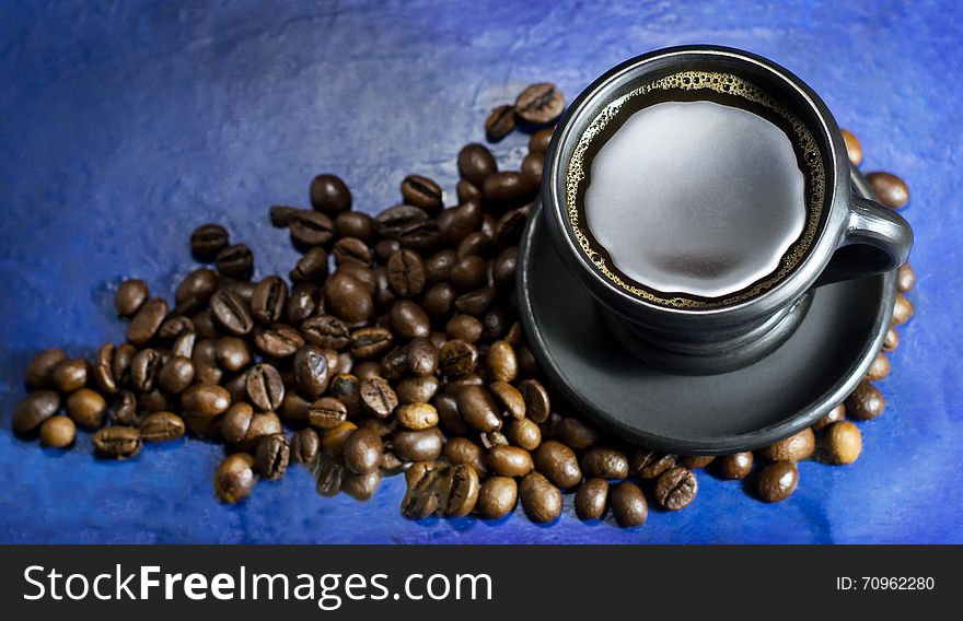 Cup of hot coffee on the old blue background