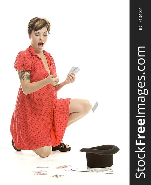 young actress with tattoos, a red girlish dress, poses different postures and expressions for an audition, with playing cards and a big black hat, over a white background. young actress with tattoos, a red girlish dress, poses different postures and expressions for an audition, with playing cards and a big black hat, over a white background