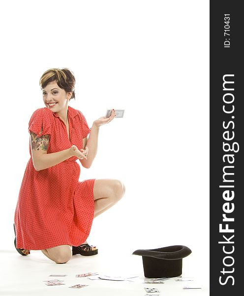 young actress with tattoos, a red girlish dress, poses different postures and expressions for an audition, with playing cards and a big black hat, over a white background. young actress with tattoos, a red girlish dress, poses different postures and expressions for an audition, with playing cards and a big black hat, over a white background