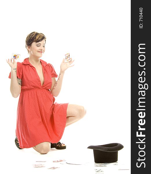 young actress with tattoos, a red girlish dress, poses different postures and expressions for an audition, with playing cards and a big black hat, over a white background. young actress with tattoos, a red girlish dress, poses different postures and expressions for an audition, with playing cards and a big black hat, over a white background