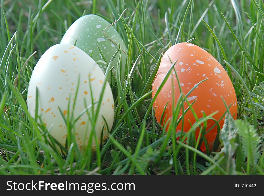 Three speckled eggs in the grass