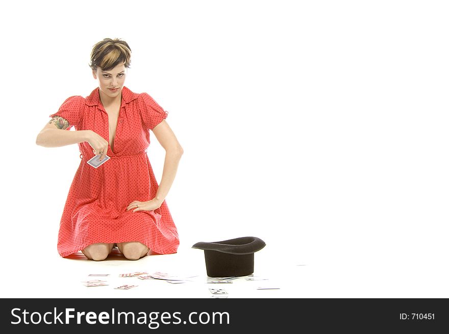 young actress with tattoos, a red girlish dress, poses different postures and expressions for an audition, with playing cards and a big black hat, over a white background. young actress with tattoos, a red girlish dress, poses different postures and expressions for an audition, with playing cards and a big black hat, over a white background