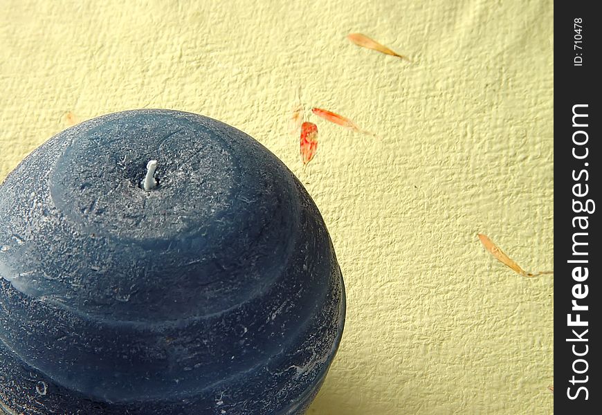 A candle on textured letter paper