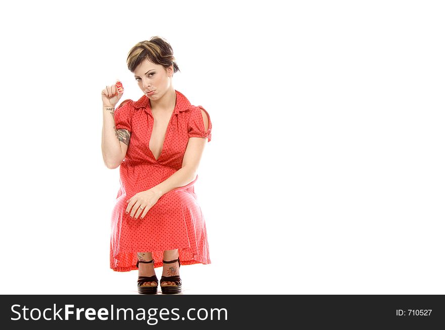 young actress with tattoos, a red girlish dress, poses different postures and expressions for an audition, playing with dices, down on the white floor. young actress with tattoos, a red girlish dress, poses different postures and expressions for an audition, playing with dices, down on the white floor