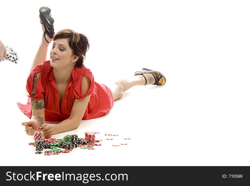 young actress with tattoos, a red girlish dress, poses different postures and expressions for an audition, with tokens in front of her, down on the white floor, while someone hands her some cards. young actress with tattoos, a red girlish dress, poses different postures and expressions for an audition, with tokens in front of her, down on the white floor, while someone hands her some cards