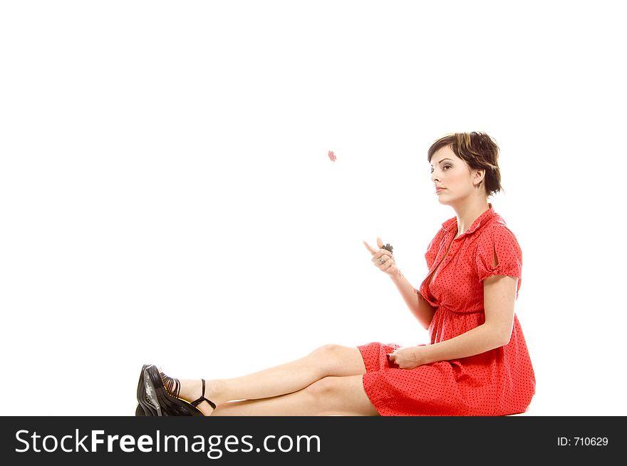 young actress with tattoos, a red girlish dress, poses different postures and expressions for an audition, throwing dices, over a white background. young actress with tattoos, a red girlish dress, poses different postures and expressions for an audition, throwing dices, over a white background