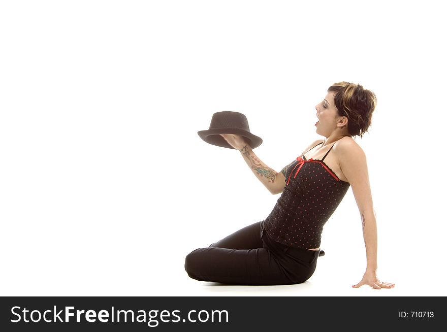 Woman in her thirties playing with a black hat. Woman in her thirties playing with a black hat