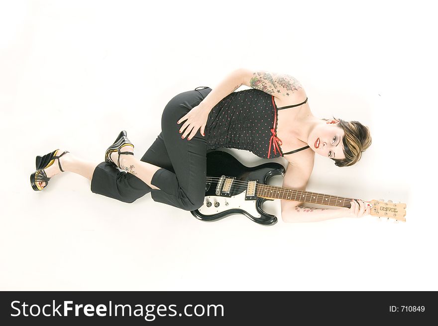 Woman in her thirties playing music on electric guitar. Woman in her thirties playing music on electric guitar