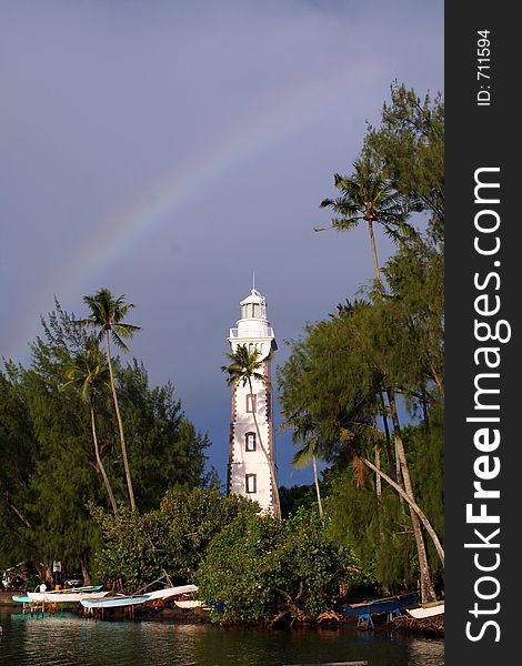 Lighthouse under a rainbow