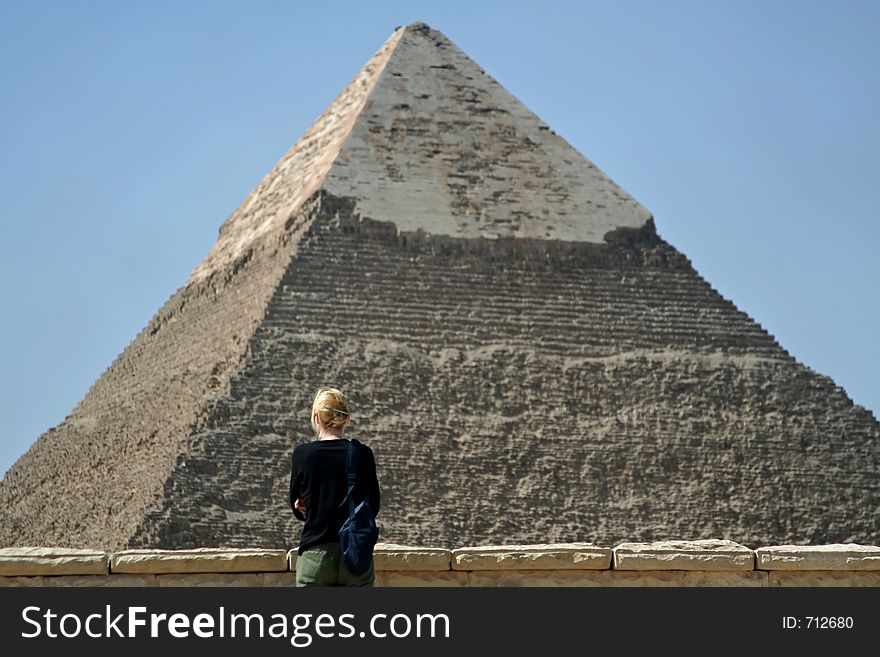 A lady in front of the pyramid. A lady in front of the pyramid