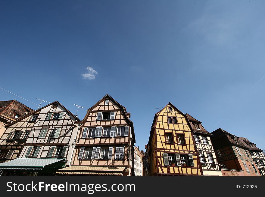 In the street of a alsacian villlage in the summer, in Colmar, half timbered traditional house. In the street of a alsacian villlage in the summer, in Colmar, half timbered traditional house