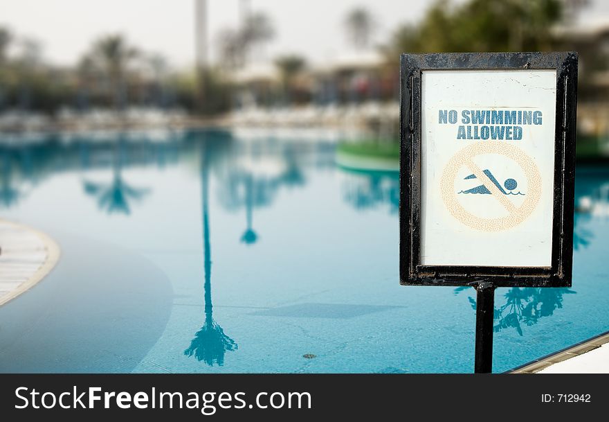 No Swimmin Allowed over swimming pool background. No Swimmin Allowed over swimming pool background.