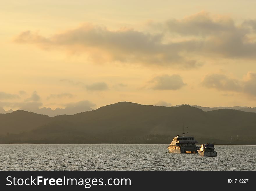 Boats crossing the calm seas during sunset near Langkawi Island, Malaysia. Boats crossing the calm seas during sunset near Langkawi Island, Malaysia