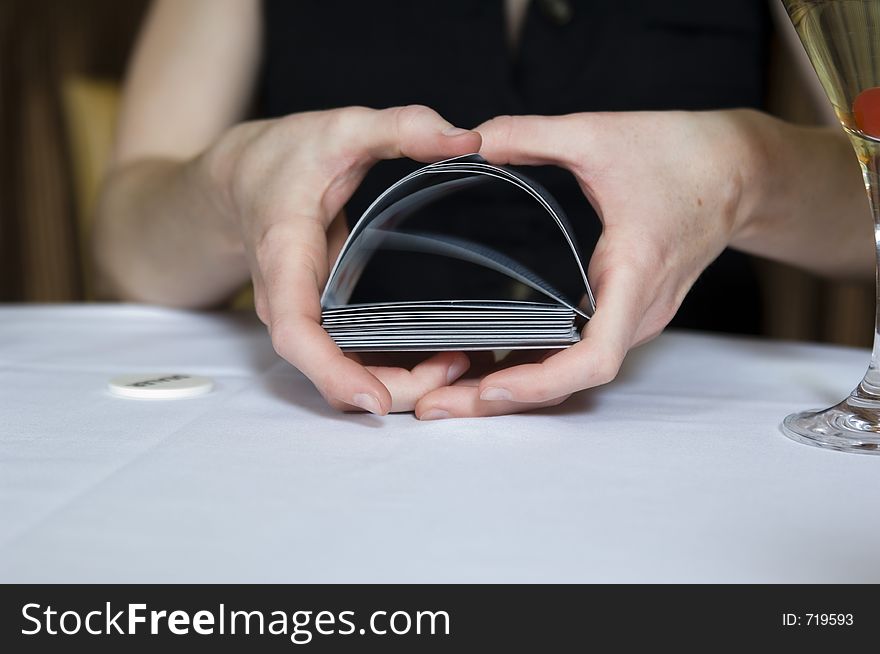 Close-up shot on a woman's hands shuffling the cards during a poker game