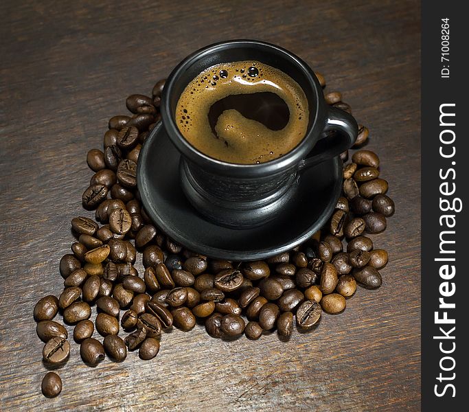 Cup of hot coffee on wooden background