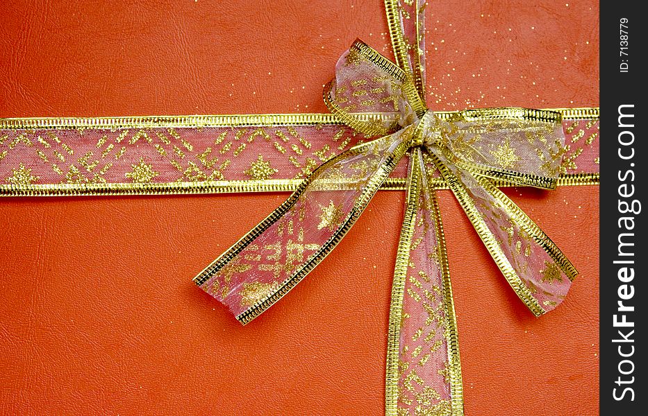 Golden ribbon on red background. Golden ribbon on red background