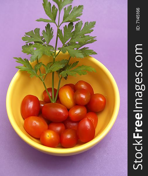 yellow porcelain pot with cherry tomatoes and parsley