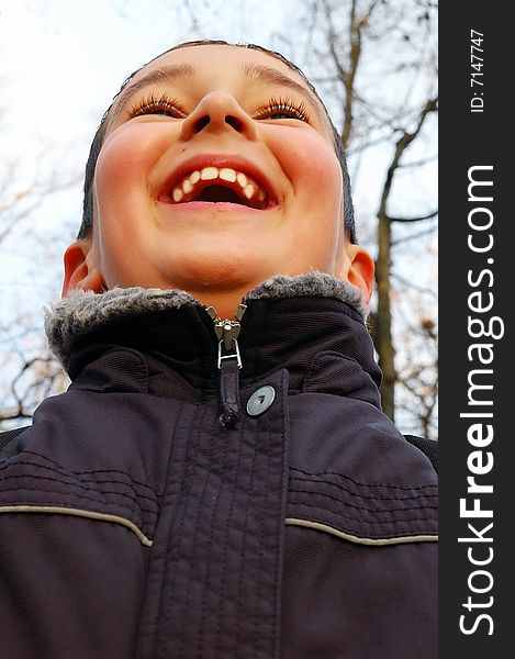 Laughing boy looking up- low angle view. Laughing boy looking up- low angle view