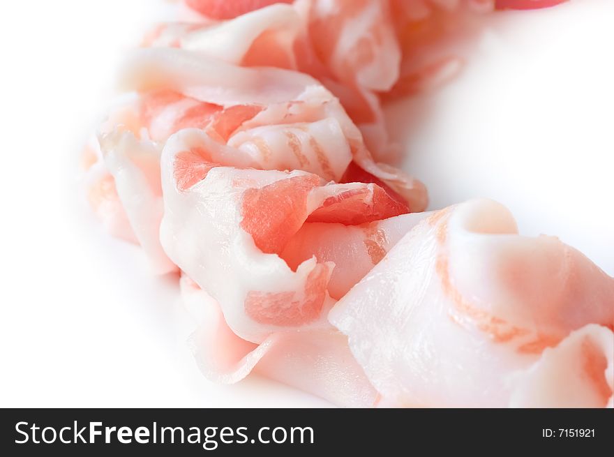 Slices of prosciutto, italian ham on white background