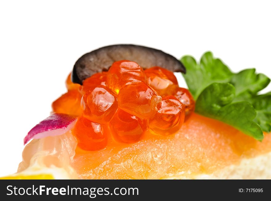 Macro shot of canape with red caviar, cmoked salmon and vegetables