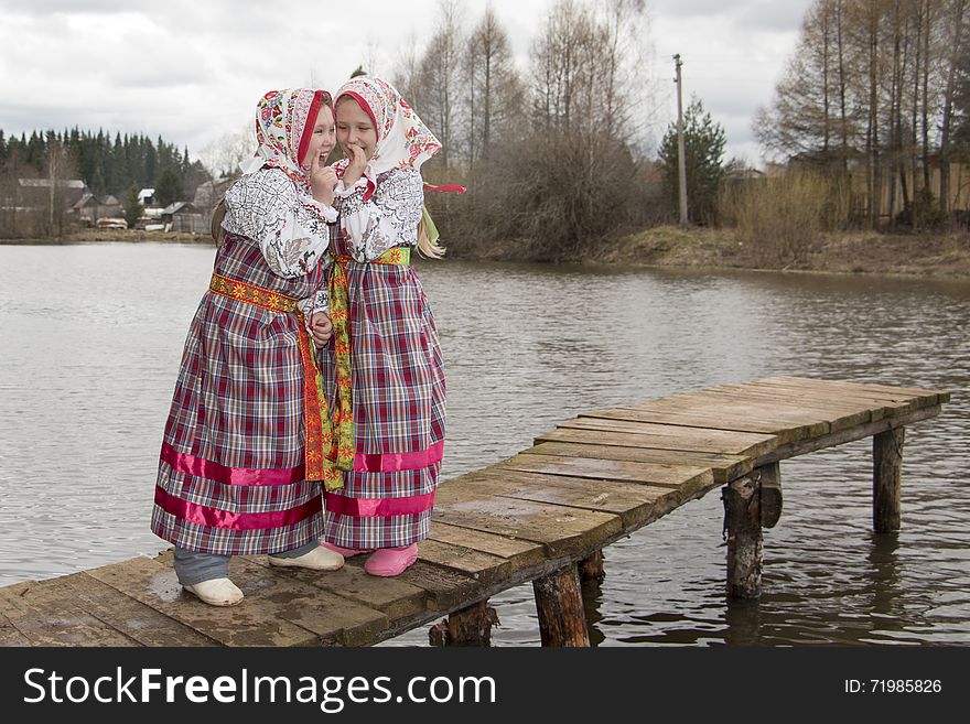 Girl in national dress near lake