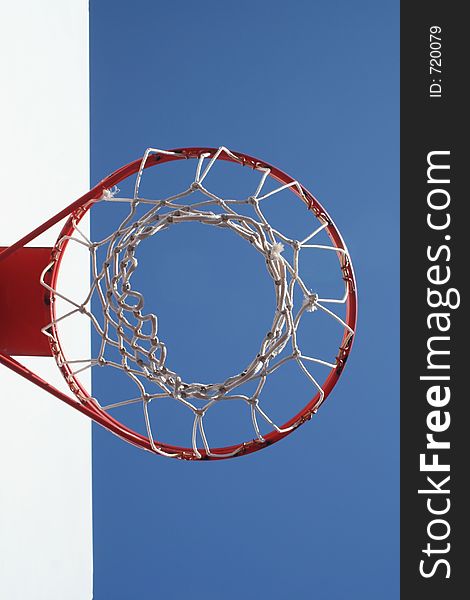 A Basketball Net Displayed against a Blue Sky Creates an Abstract Design. A Basketball Net Displayed against a Blue Sky Creates an Abstract Design.