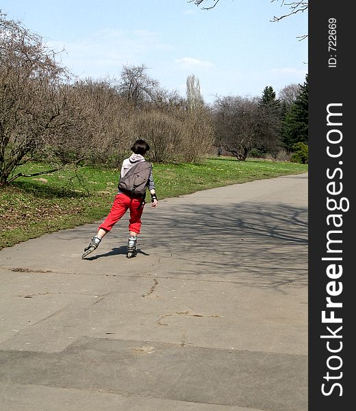Girl on a rolling skates in a park. Girl on a rolling skates in a park