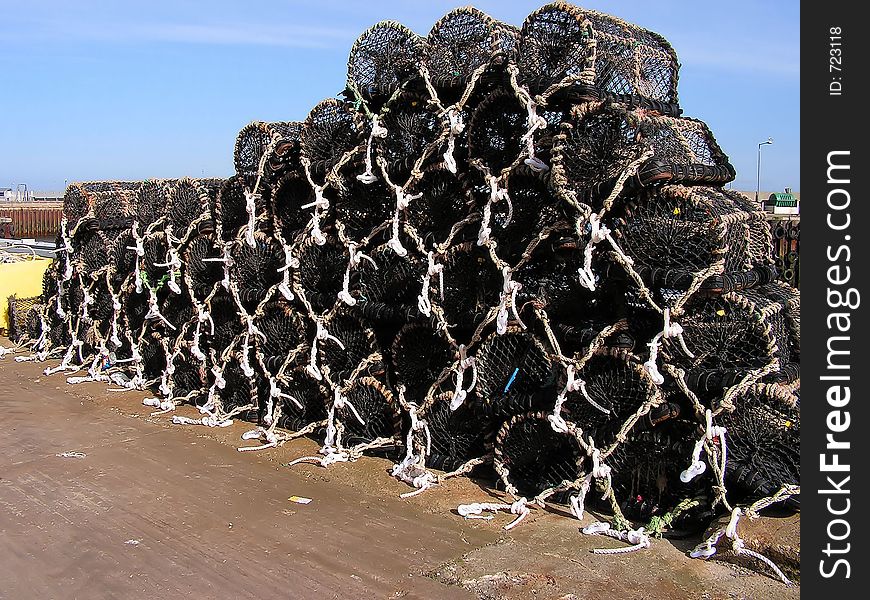 A load of creels for either lobsters or crabs waiting quayside to be taken to sea and laid out in their chain. Replacement ropes can be seen. A load of creels for either lobsters or crabs waiting quayside to be taken to sea and laid out in their chain. Replacement ropes can be seen.
