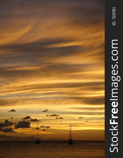 Colourful caribbean sunset with sailboats. Colourful caribbean sunset with sailboats