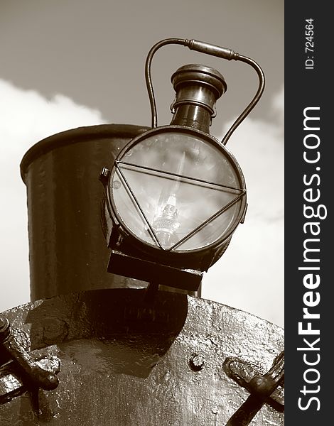 Detail of steam train: exhaust with lamp. Sepia toned image. Detail of steam train: exhaust with lamp. Sepia toned image