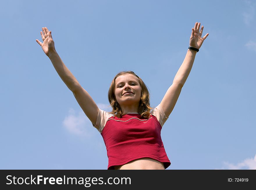 Girl in the clear sky with her hands up. Girl in the clear sky with her hands up
