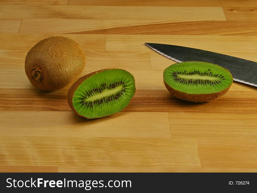 Kiwi on cutting Board With Knife