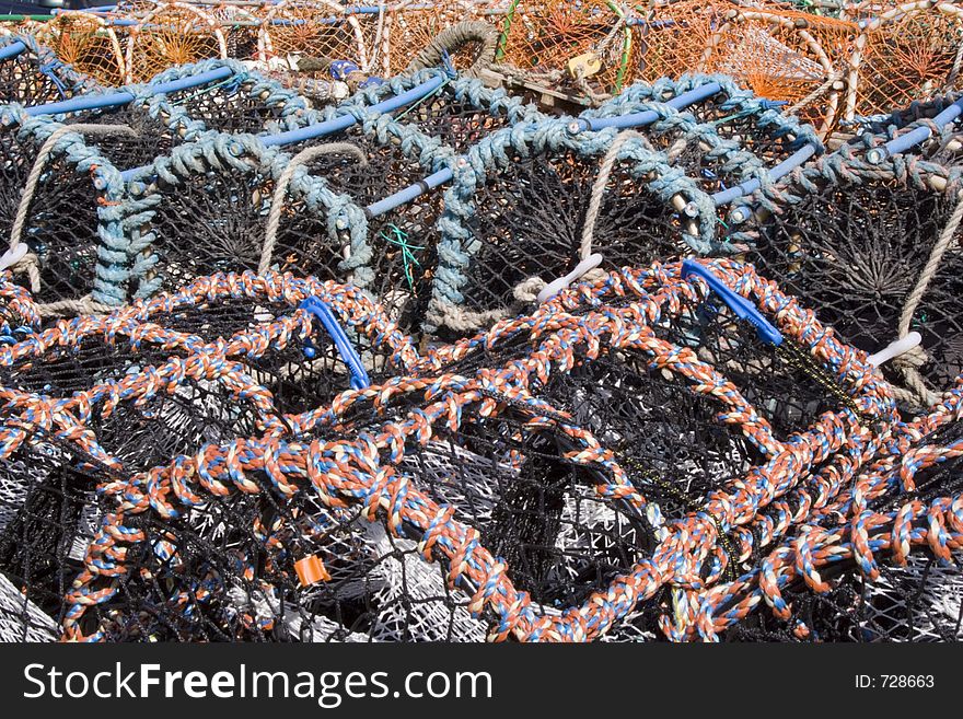 Multi-colored lobster traps piled high on the shore. Interesting textures and colors. Multi-colored lobster traps piled high on the shore. Interesting textures and colors.