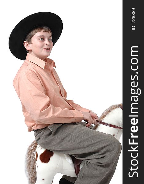 Teen boy makes fun of toy horse. When he grows up, he wants to be a cowboy. Teen boy makes fun of toy horse. When he grows up, he wants to be a cowboy.