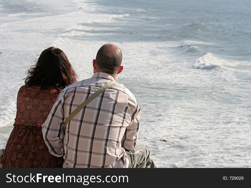 Couple watching the surf