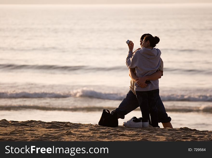 Couple hugging and looking at a camera. Couple hugging and looking at a camera