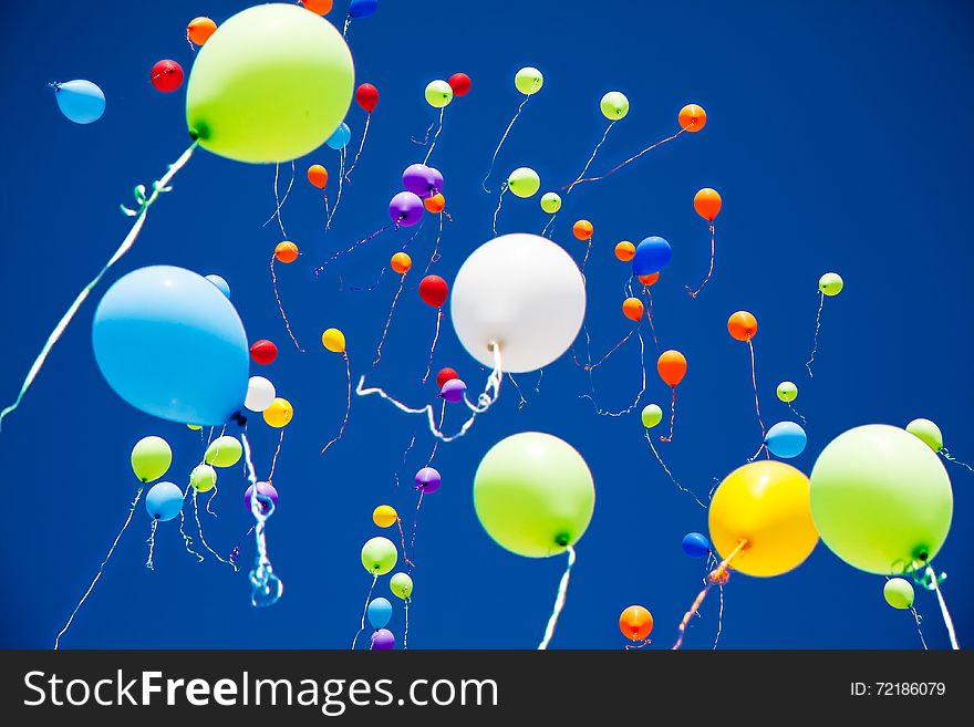 A lot of bright colorful balloons in the sky